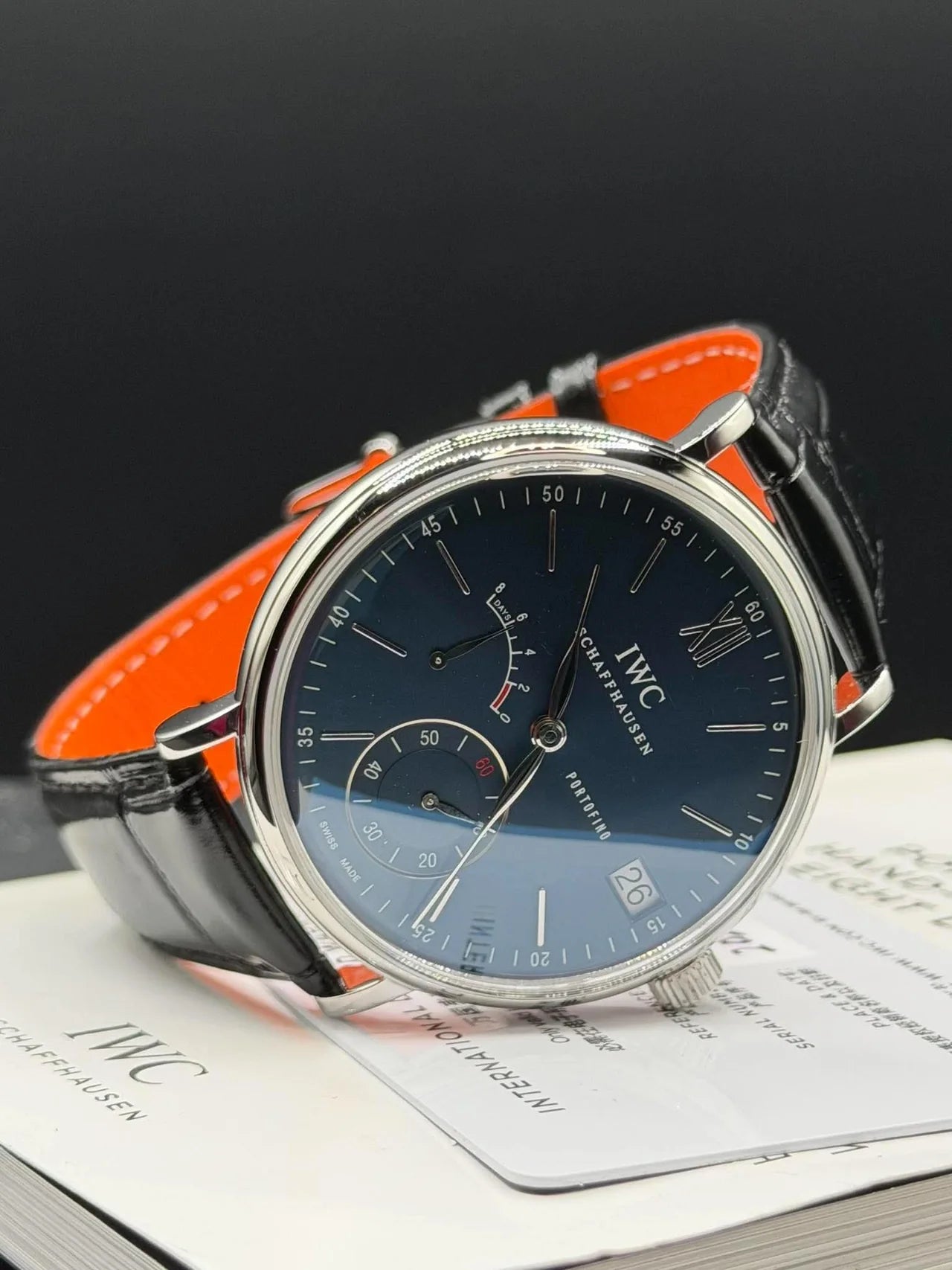 Blue dial dress watch with an orange leather strap