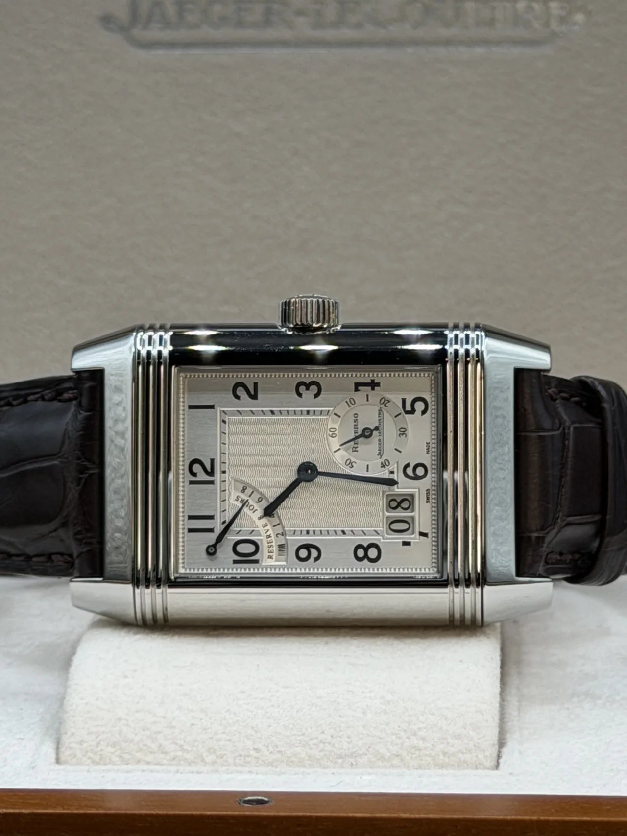 Rectangular white dial watch with a black leather strap