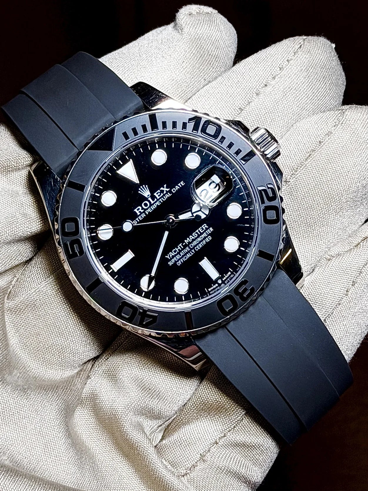 Black dial diving watch with a blue rubber strap