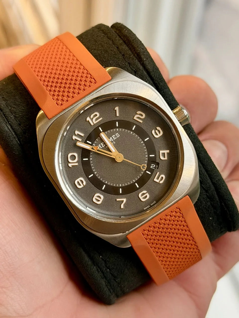 Bronze-tone watch with a brown dial and orange strap