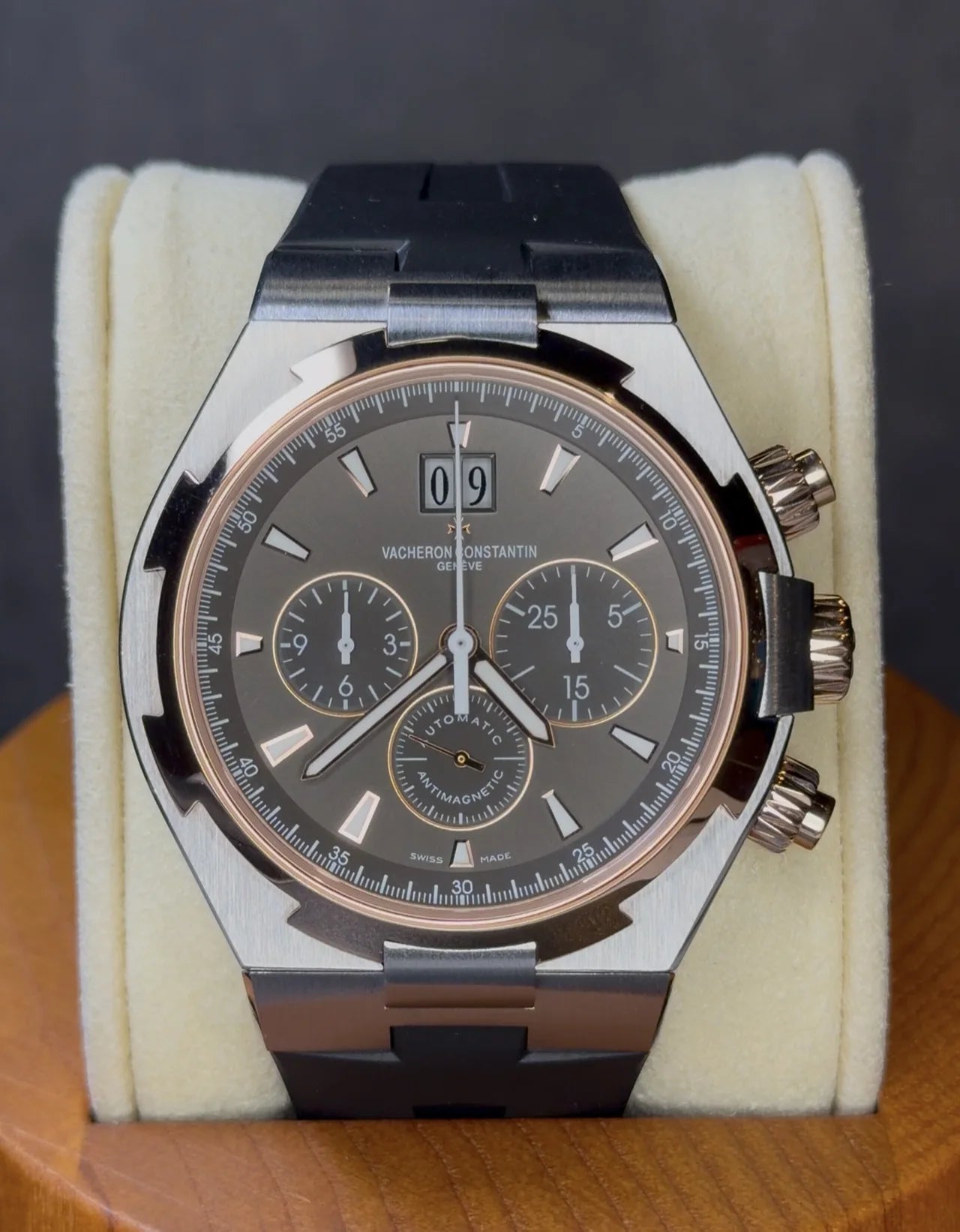 Grey chronograph with a dark strap on a watch cushion