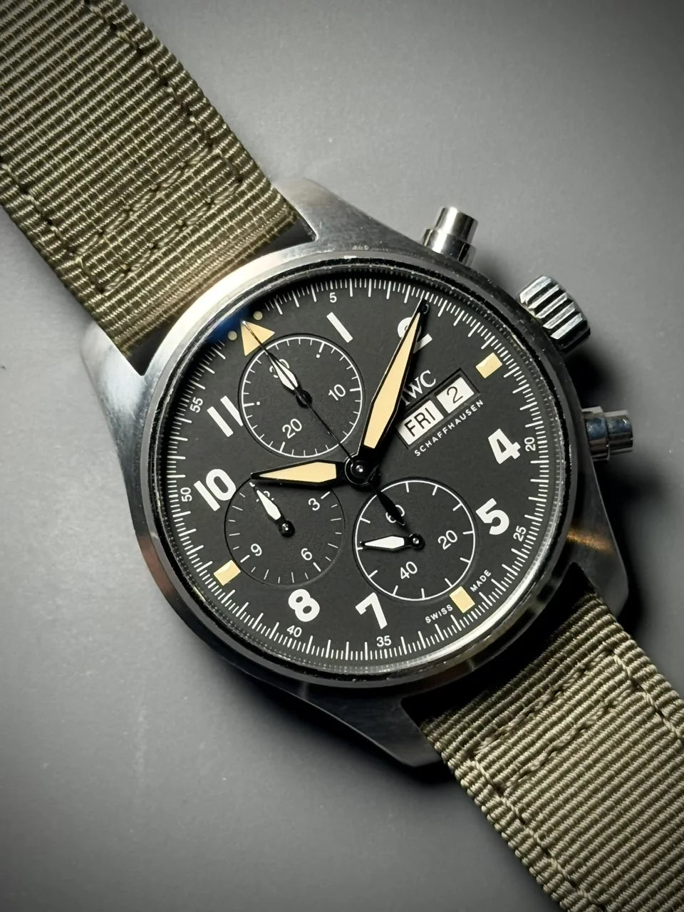 Dark chronograph with an olive fabric strap