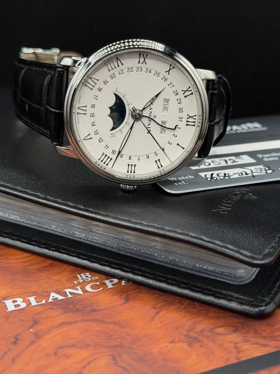 White dial watch with subdials and a black leather strap
